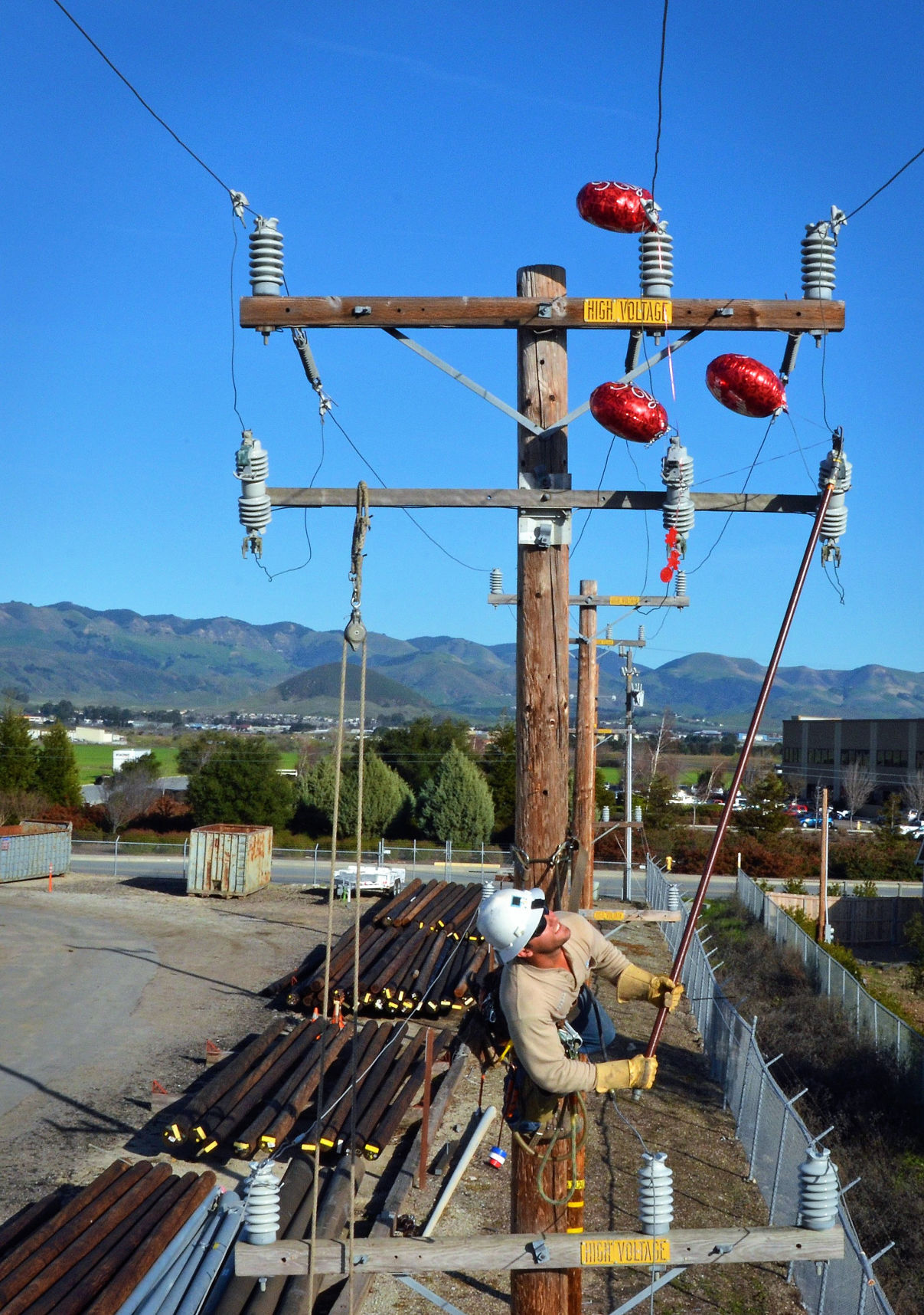 PG&E lineman removing balloons.jpg